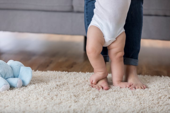 Baby walking on an area rug