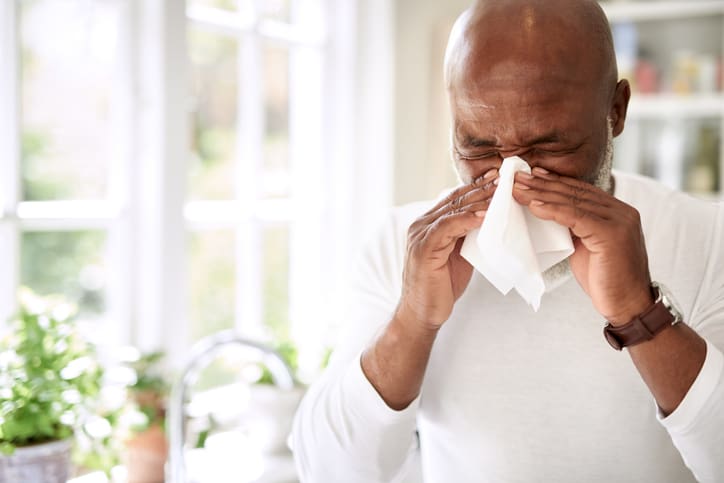 man sneezing